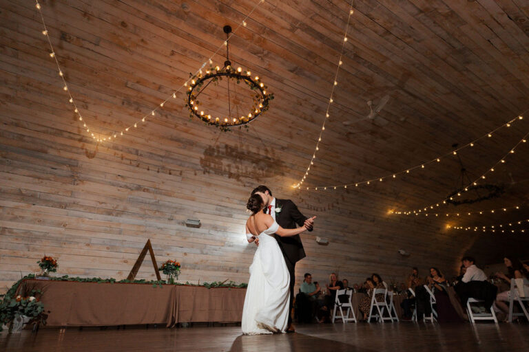newlyweds first dance in rustic barn wedding venue